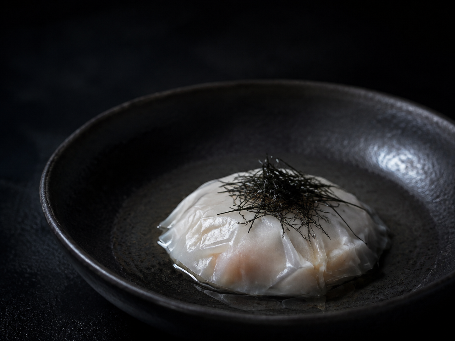 Veil: Kanpachi under a rice veil, sea herbs, clear broth